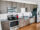 Apartment kitchen furnished with stainless steel appliances